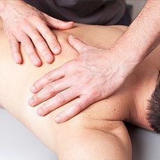 Mid Back Pain Man receiving chiropractic treatment on his back